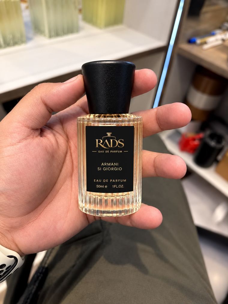 A RADS Eau de Parfum bottle in hand